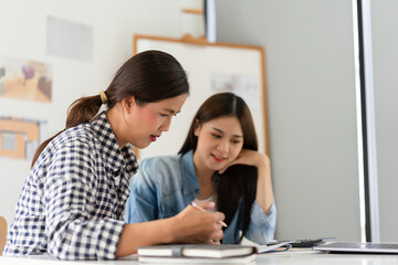 Construction business plan concept, Two architects discuss about project and blueprint of building