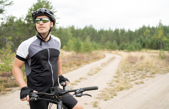 Uses a fitness watch a cyclist on a mountain bike in a helmet and equipment eco tourism