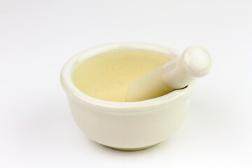 White ceramic mortar and pestle isolated on white background.