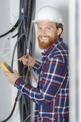 electrician using multimeter in renovation property