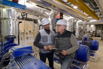 two factory workers in workshop