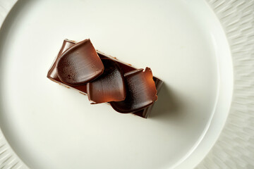 Chocolate mousse cake with frosting. Noise added in post-production. Selective focus