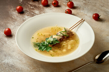 Soup with gnocchi and meat in a bowl. Selective focus, close-up