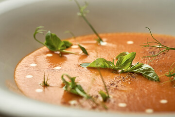Pumpkin cream soup with jamon and sausages. Noise added in post-production. Selective Focus.