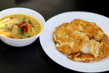 Spicy chicken green curry served with rice and deep fried egg, tasty Thai food