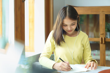 Education and literacy concept, College student girl use phone to listening lecture and taking note