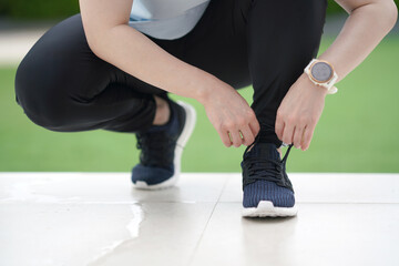 woman tying shoelace of run shoe for jogging