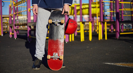 Skateboard and helmet. Fall protection red helmet.