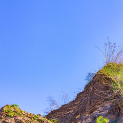 Excavated sand mountains and rubble piles quarry lake dredging pond.