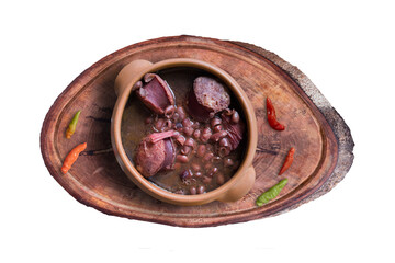 Feijoada. Traditional Brazilian food. Ceramic bowl isolated on rustic wooden background. Top view.
