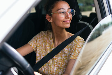 Young woman driving modern car