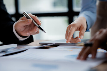 The sales department is having a monthly summary meeting to bring it to the department manager, they are verifying the correctness of the documents that are prepared before bringing in to the manager