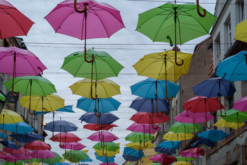 Fototapeta na wymiar CITYSCAPE - Colorful umbrellas above the promenade in the city center