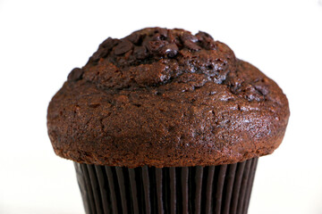 Close up of a delicious double chocolate chip muffin cake isolated by white background