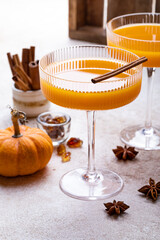 Halloween, Thanksgiving or fall cocktail pumpkin martini, homemade festive seasonal drink pumpkintini with cinnamon
