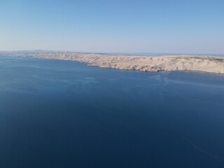 Aerial view of Prizna, Trajekt Prizna-Zigljen to reach the island of Pag. Drone view of queue to catch ferry for Pag. Small town with turquoise water on the hill of Croatia, in Dalmatia.