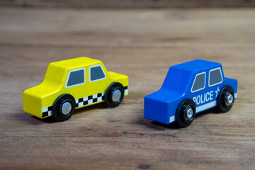 Fototapeta na wymiar children toy, taxi , polic cars, isolated on wooden background