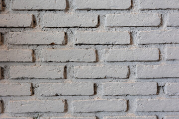 Front view and close up shot of concrete and with stack and row of brick wall shows pattern and grunge texture of old and vintage building. It is beautiful background and backdrop for loft design.