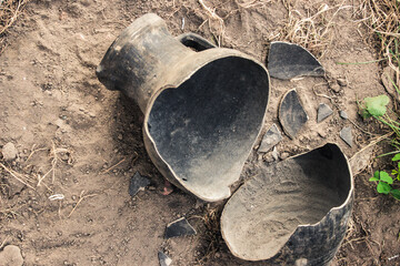 Broken earthenware jug for wine on the ground. Excavations of ancient clay jugs.