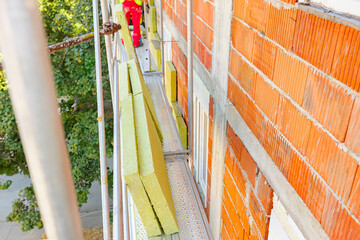View at unfinished thermal wall of residential building, insulation material, rock wool placed on...