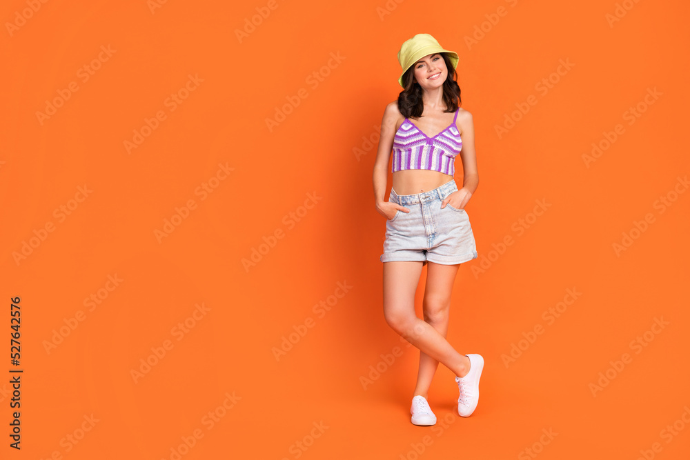 Sticker Full length photo of sweet brunette lady stand wear hat top jeans shorts boots isolated on orange color background