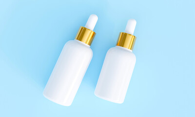 White Serum glass bottles isolated on blue background. 3D Rendering