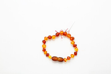Amber bracelet on a white background. Place for an inscription on the product label. Jewelry for women. semi-precious mineral. Copal. Fossil fossilized resin. Crystal.  Decorations 