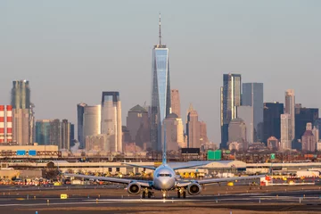 Airplane have just landed in airport Newark. Passenger plan on runway strip to go to Terminal of airport. New York city on background of airplane © dima