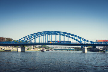 Fototapeta na wymiar Marshal Piłsudski Bridge. Blue steel construction on the Vistula river. Cracow, Poland
