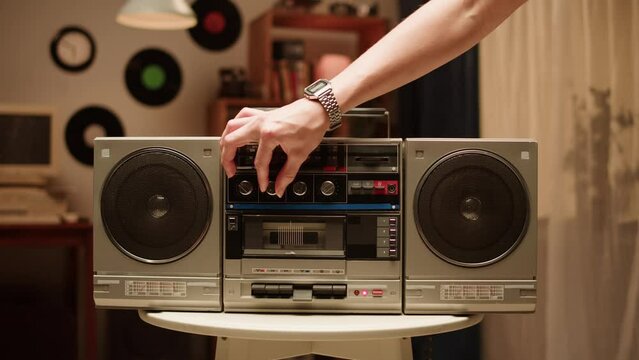 Retro radio tape recorder close-up. Listening to music, old radio boombox player at home, searching channel or wave. 