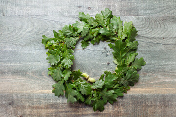 Beautiful wreath of oak leaves , typical Scandinavian midsummer decoration concept. Wooden...