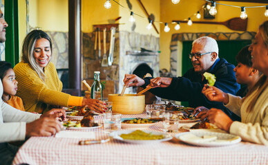 Happy latin family having fun eating together home - Focus on grandfather face