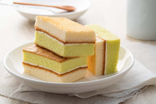 pandan flavour layer cake ,Sweet green color and pandan aroma from pandan leaves on white plate