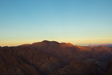 Naklejka na ściany i meble Amazing Sunrise at Sinai Mountain, Mount Moses with a Bedouin, Beautiful view from the mountain