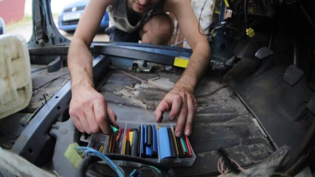 auto mechanic electrician uses electrical insulation heat shrink