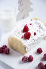 Christmas cake with whipped cream and raspberries