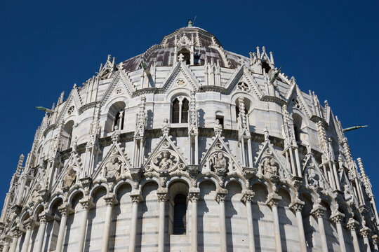 Pisa, Tuscany, Italy 08-28-2022. Details the architecture of the Pisa Baptistery, dedicated to Saint John the Baptist, faces the cathedral at the western end of the Piazza dei Miracoli.