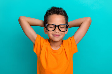 Photo of funny charming small man wear yellow t-shirt eyeglasses arms behind head closed eyes...