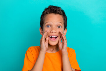 Photo of funky excited small man wear yellow t-shirt shouting you announcement isolated turquoise color background