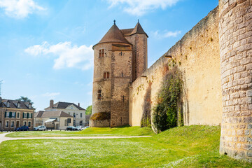 Fototapeta na wymiar Walls and towers of Blandy-les-Tours castle from the village