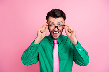 Closeup photo of young funny guy hold eyeglasses looking you smiling new employee isolated on pink color background