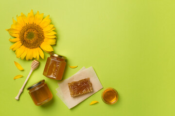 Flat lay with sunflower honey on color background, top view