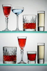 Various alcoholic drinks on glass shelves.