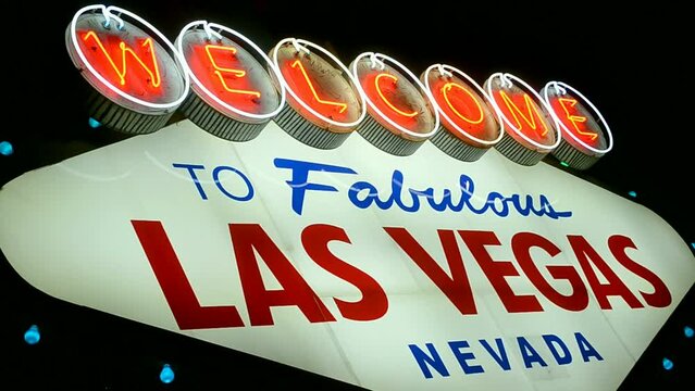 Las Vegas sign with blinking red led light on dark night sky, Nevada, USA. Welcome to fabulous sin city, entertainment diversity