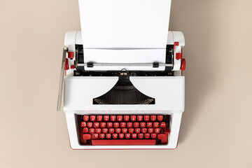 Top view of a retro typewriter with blank white paper. Creative writing process concept
