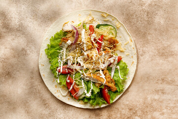 Tortillas, Flatbread with chicken meat, lettuce, tomatoes, cheese, sauce. Easy to cook sandwich on beige background. Healthy snack, cooking taco.
