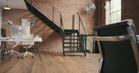 Office, room and creative space with table, desk and furniture for business meeting, collaboration and teamwork. Modern interior design in startup company, building and property for strategy planning