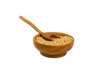Raw pine nuts in wooden scoop isolated on white background