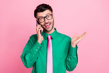 Photo of excited impressed guy wear green shirt spectacles talking modern device isolated pink color background
