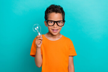 Photo of impressed pretty small man wear yellow t-shirt eyeglasses rising light bulb isolated...